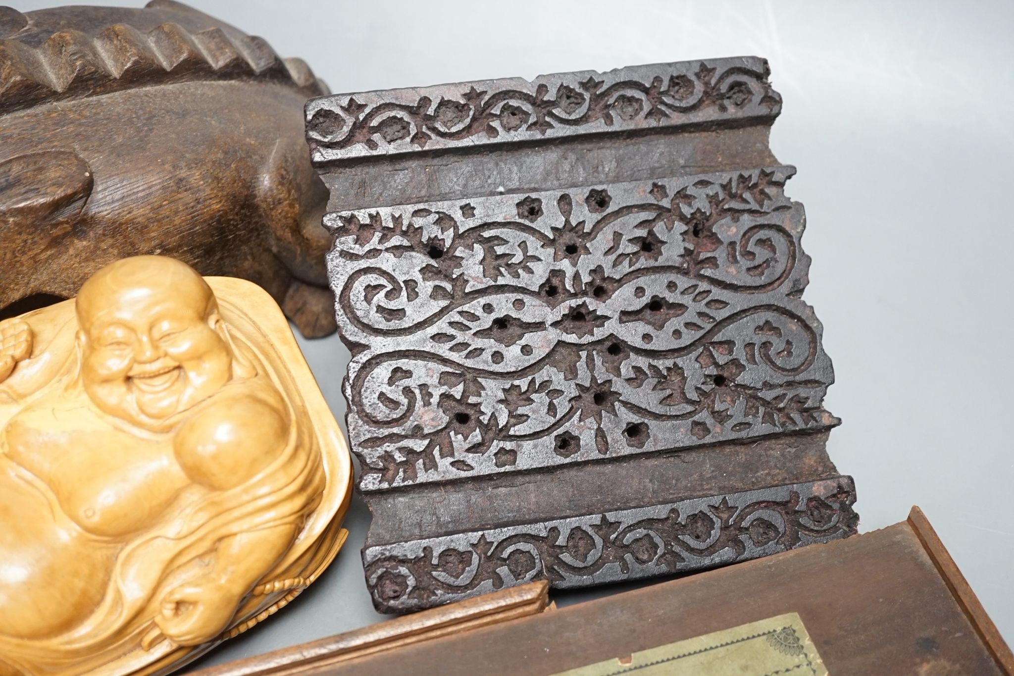 A Chinese carved wood frog, 22cm long, a carved Buddha, woodblock and a part-set of draughtsmen
